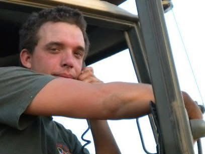 stu mendelson Soldier in a military vehicle wearing a helmet and tactical gear.