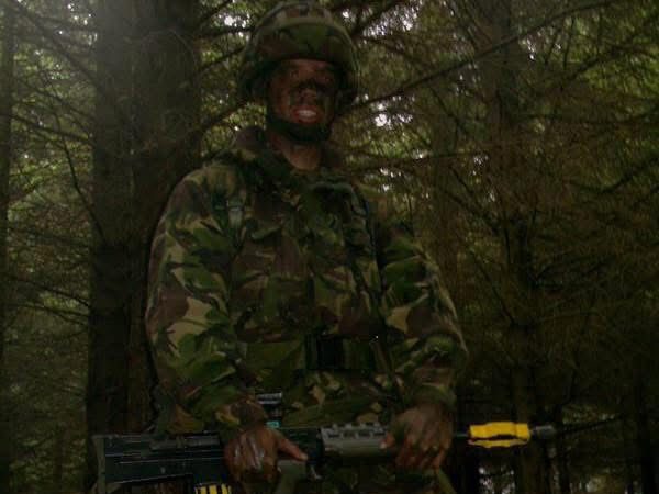 stu mendelson Soldier in military uniform posing in front of an armoured vehicle.